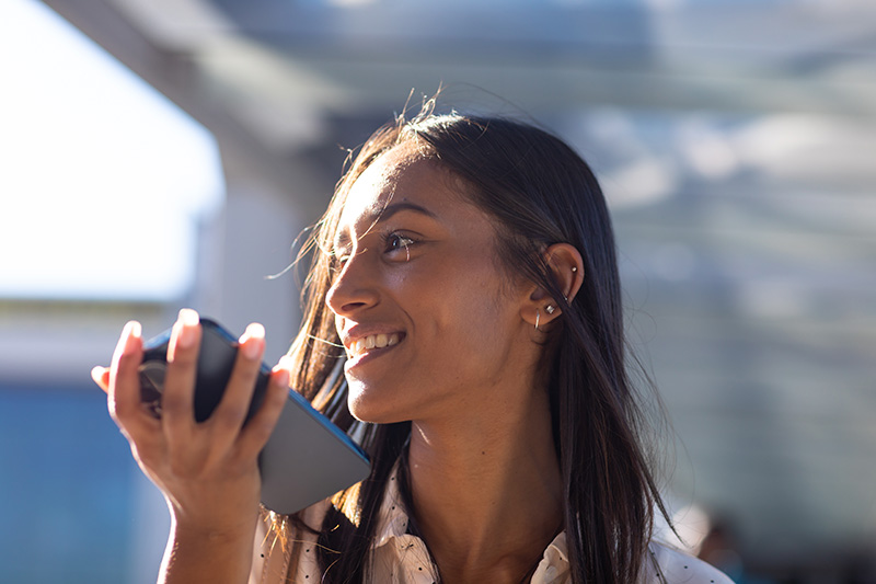 Woman doing a voice search for SEO on her phone